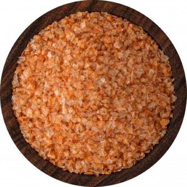 Sriracha Sea Salt from The Olive Tap:  A wooden bowl filled with pebble-sized chunks of salmon-colored sea salt against a white background.